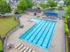 Aerial view of a community pool with lounge chairs, picnic tables, and ample parking at 9805 Precious Stone Dr, Wake Forest, NC 27587
