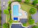 Aerial view of a community pool with lounge chairs, picnic tables, and umbrellas for residents' enjoyment at 9805 Precious Stone Dr, Wake Forest, NC 27587
