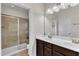 Bathroom featuring a double vanity, walk-in shower with glass door, and tile flooring at 1001 Tender Dr, Apex, NC 27502