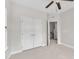 This bedroom features a ceiling fan, closet, and a doorway to a hallway at 1001 Tender Dr, Apex, NC 27502