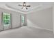 This large bedroom has lots of natural light and a trey ceiling with a fan at 1001 Tender Dr, Apex, NC 27502