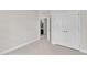 An airy bedroom featuring neutral walls and carpet with a doorway leading to the bathroom at 1001 Tender Dr, Apex, NC 27502