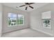 Bedroom with large windows letting in lots of natural light and a ceiling fan at 1001 Tender Dr, Apex, NC 27502