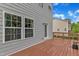 View of the deck with gray siding and a glimpse of the trees in the backyard at 1001 Tender Dr, Apex, NC 27502