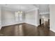 Bright dining room with hardwood floors, classic trim, and stylish chandelier; open floor plan view to kitchen at 1001 Tender Dr, Apex, NC 27502
