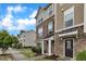 Row of townhomes featuring a combination of stone and siding exterior, complemented by a well-maintained lawn at 1001 Tender Dr, Apex, NC 27502