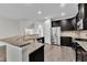 Modern kitchen with granite countertops, stainless steel appliances, and dark cabinetry for a sleek design at 1001 Tender Dr, Apex, NC 27502