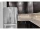 This kitchen features stainless steel appliances, dark cabinets, and granite countertops at 1001 Tender Dr, Apex, NC 27502