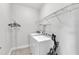 Bright laundry room includes modern washer and dryer and shelving for storage at 1001 Tender Dr, Apex, NC 27502