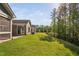 Backyard with lush lawn, screened porch, concrete patio, exterior siding, and trees at 1009 Middleground Cir, Durham, NC 27713