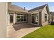 Spacious backyard features a concrete patio, siding, windows, and glass doors that lead to the home's interior at 1009 Middleground Cir, Durham, NC 27713