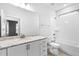 Well-lit bathroom with granite counters, white cabinetry, and tub shower combo at 1009 Middleground Cir, Durham, NC 27713