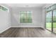 An empty room with light grey flooring, white walls, and a large window, ready to be transformed into a bedroom at 1009 Middleground Cir, Durham, NC 27713
