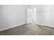 A neutral bedroom with hardwood floors and a doorway leading to another room at 1009 Middleground Cir, Durham, NC 27713