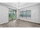 Dining area features sliding glass doors for outdoor access and several windows for natural light at 1009 Middleground Cir, Durham, NC 27713
