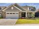 Charming home featuring stone accents, well-manicured lawn, and attached two car garage at 1009 Middleground Cir, Durham, NC 27713