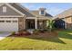 Beautiful home featuring a landscaped front yard, covered porch, and stone and siding facade at 1009 Middleground Cir, Durham, NC 27713