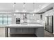 Stylish kitchen featuring a large center island, white cabinets, and stainless steel appliances at 1009 Middleground Cir, Durham, NC 27713