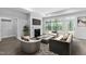 Bright living room featuring a fireplace, large windows, and stylish modern furniture and decor throughout the space at 1009 Middleground Cir, Durham, NC 27713