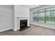 Bright living room showcases a fireplace, large windows, and neutral paint, offering a cozy atmosphere at 1009 Middleground Cir, Durham, NC 27713
