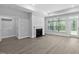 Bright living room boasts a fireplace, large window, and access to the outdoors at 1009 Middleground Cir, Durham, NC 27713
