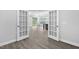 Open view of living room from doorway with hardwood floors and light-filled rooms at 1009 Middleground Cir, Durham, NC 27713