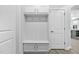 A mudroom with storage hooks and a storage bench beside a door at 1009 Middleground Cir, Durham, NC 27713