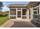Screened porch showcases entry door, screen windows, and views of the manicured lawn and home exterior at 1009 Middleground Cir, Durham, NC 27713