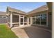 View of screened porch with access door and windows, next to a concrete patio, exterior siding, and rain gutters at 1009 Middleground Cir, Durham, NC 27713