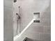 Tiled shower stall with dual shower heads and convenient shelf, perfect for a refreshing and comfortable shower experience at 1009 Middleground Cir, Durham, NC 27713
