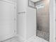 Modern bathroom featuring a tiled walk-in shower with grey tiling and a glass door, offering a spa-like experience at 1009 Middleground Cir, Durham, NC 27713