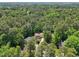 Aerial view of home surrounded by lush mature trees at 106 Shady Point Ct, Durham, NC 27713