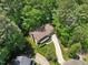 Aerial view of a well-maintained two-story home with a large driveway, surrounded by lush trees at 106 Shady Point Ct, Durham, NC 27713