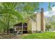 View of the backyard showcasing the screened in porch and an outdoor wooden deck at 106 Shady Point Ct, Durham, NC 27713