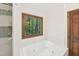 Bathroom featuring a jetted tub with a window view, and a shower with a tiled wall accent at 106 Shady Point Ct, Durham, NC 27713