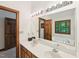 Bathroom with double sinks, large mirror, and a jetted tub with a window view at 106 Shady Point Ct, Durham, NC 27713