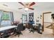 Spacious room with ceiling fan, two workstations, and natural light at 106 Shady Point Ct, Durham, NC 27713