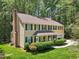 Charming two-story home with green shutters, lush landscaping, and brick chimney at 106 Shady Point Ct, Durham, NC 27713