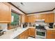 Kitchen featuring oak cabinets and stainless steel appliances by the window at 106 Shady Point Ct, Durham, NC 27713