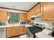 Kitchen featuring oak cabinets and stainless steel appliances by the window at 106 Shady Point Ct, Durham, NC 27713