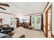 Bright living room with white walls, wood trim, and doors to deck at 106 Shady Point Ct, Durham, NC 27713