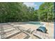 Community pool area with lounge chairs and surrounded by a wooded area, perfect for relaxation at 106 Shady Point Ct, Durham, NC 27713