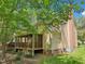 View of back of house featuring screened-in porch and brick chimney at 106 Shady Point Ct, Durham, NC 27713