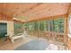 Relaxing screened porch with wood accents, seating, and backyard views at 106 Shady Point Ct, Durham, NC 27713