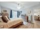 Comfortable bedroom with neutral tones, ceiling fan, wood flooring, and a glimpse into the dining area at 107 Sturbridge Dr, Clayton, NC 27520