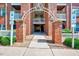 Charming brick apartment building entrance with dedicated accessible parking and decorative metal archway at 107 Sturbridge Dr, Clayton, NC 27520