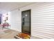 Inviting front door with a welcoming 'hello' doormat and white horizontal siding at 107 Sturbridge Dr, Clayton, NC 27520