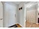Hallway showcasing a door leading to a full bathroom with modern fixtures and a patterned shower curtain at 107 Sturbridge Dr, Clayton, NC 27520