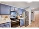 This modern kitchen boasts stainless steel appliances, lots of cabinet space, and hardwood-style flooring at 107 Sturbridge Dr, Clayton, NC 27520