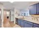 Kitchen view with blue cabinets and marble countertops at 107 Sturbridge Dr, Clayton, NC 27520